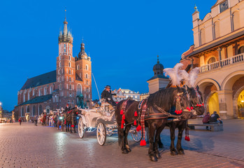 Naklejka na ściany i meble Carriages before the Sukiennice on The Main Market in Krakow