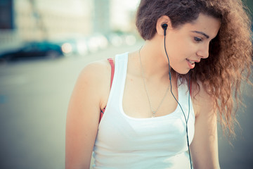 young beautiful long curly hair hipster woman listening music