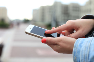 Close up of a woman using mobile smart phone