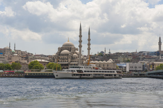 Large mosque next to river in city