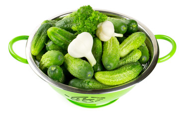 fresh cucumbers in a green colander