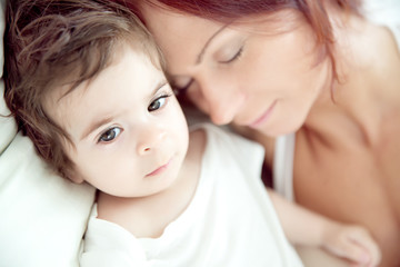 happy-looking baby and mother playing together