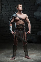 Fototapeta na wymiar Gladiator with sword posing