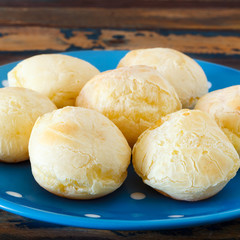 Brazilian snack cheese bread (pao de queijo) on blue plate