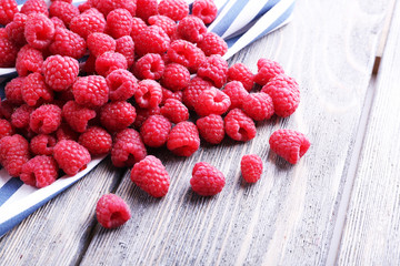 Ripe sweet raspberries on table close-up
