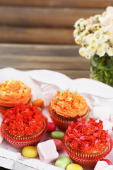 Tasty cupcakes on wooden table, close up