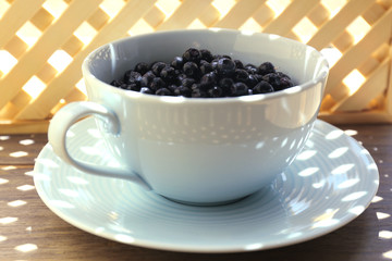 Useful blueberry in bowl on table, close-up