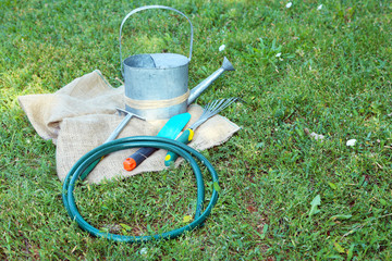 Garden tools on green grass background