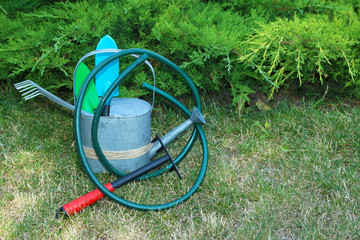 Garden tools on green grass background