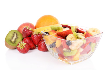 Fresh fruits salad in bowl with fruits and berries isolated