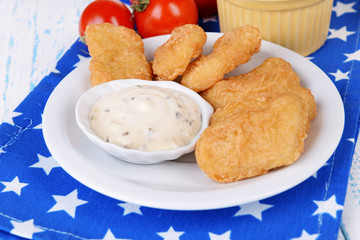 Chicken nuggets with sauce on table close-up