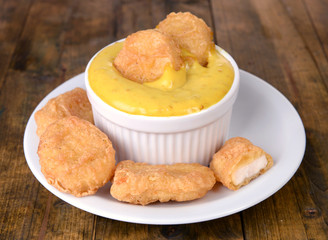 Chicken nuggets with sauce on table close-up