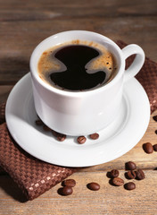 Cup of coffee on wooden background