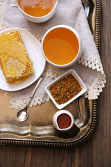 Fresh honey snack on tray on wooden table