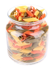 Colorful pasta in a glass jar isolated on white