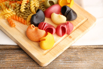Colorful pasta on wooden background