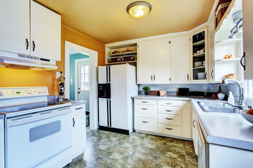White kitchen interior with peach walls and khaki linoleum