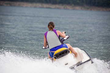 Young Woman piloting a personal water craft