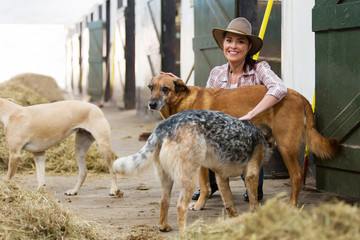 female horse stables owner and dogs
