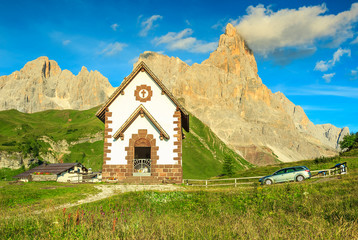Tirolian chapel,car and high mountains,Dolomites,Italy,Europe