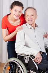 Disabled man on wheelchair and nurse