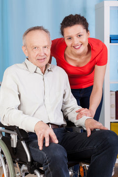 Smiling disabled man and nurse