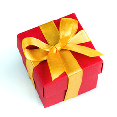Single red gift box with golden ribbon