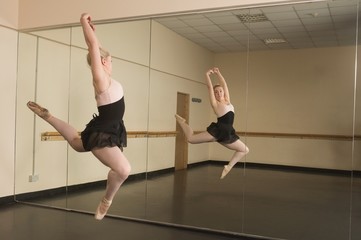Beautiful ballerina dancing in front of mirror © WavebreakmediaMicro