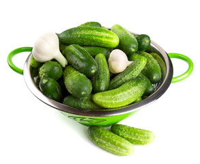 fresh cucumbers in a green colander