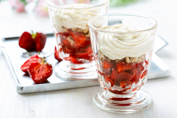 Dessert with strawberries, whipped cream and biscuit..