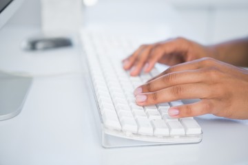 Businesswoman typing on a keyboard