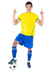 Naklejka premium Football player in yellow with ball