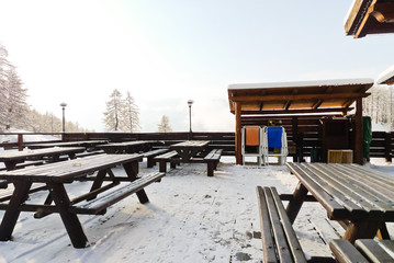 empty wooden tables in mountain restaurant