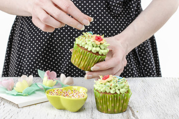 Woman decorating cupcakes