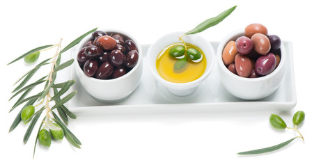 Assorted pitted olives with olive oil in a ceramic bowls