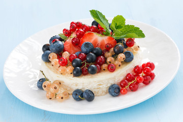 mini cheesecake with fresh berries on a blue background