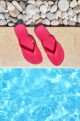 Flip flops by the poolside with water and copy-space