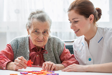 Senior woman with her elder care nurse