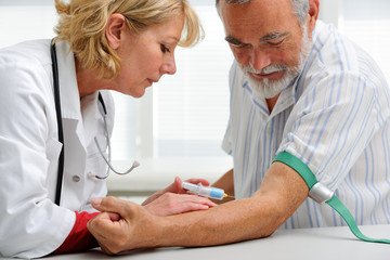doctor with syringe is taking blood for test