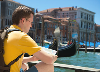 Fototapeta na wymiar Young man with map in Venice