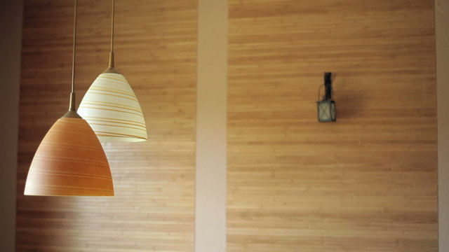 two beautiful chandeliers on the background of wooden wall