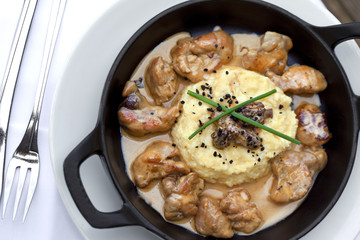 Sweetbreads with sauce in a dish, pollenta and morels