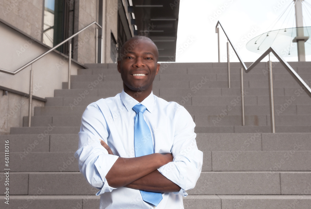 Wall mural african businessman with stairs in the background