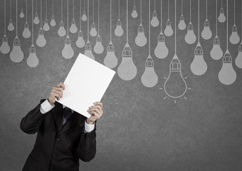 businessman showing the book of drawing idea light bulb concept