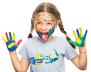 Portrait of a cute girl playing with paints