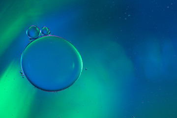 Abstract two bubbles of water bonding to a another