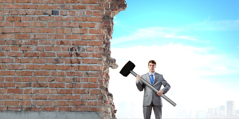 Businessman holding hammer