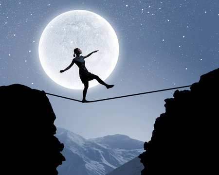Woman walking on rope