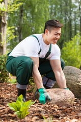 Gardener lifting up a stone