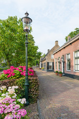 Old street with historic houses in a Dutch village